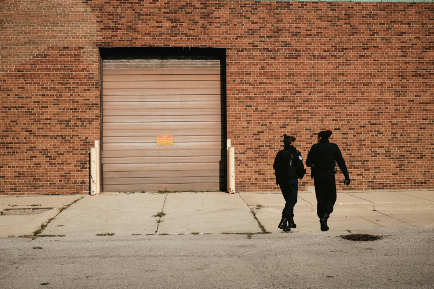 Security officer performing perimeter check at industrial site